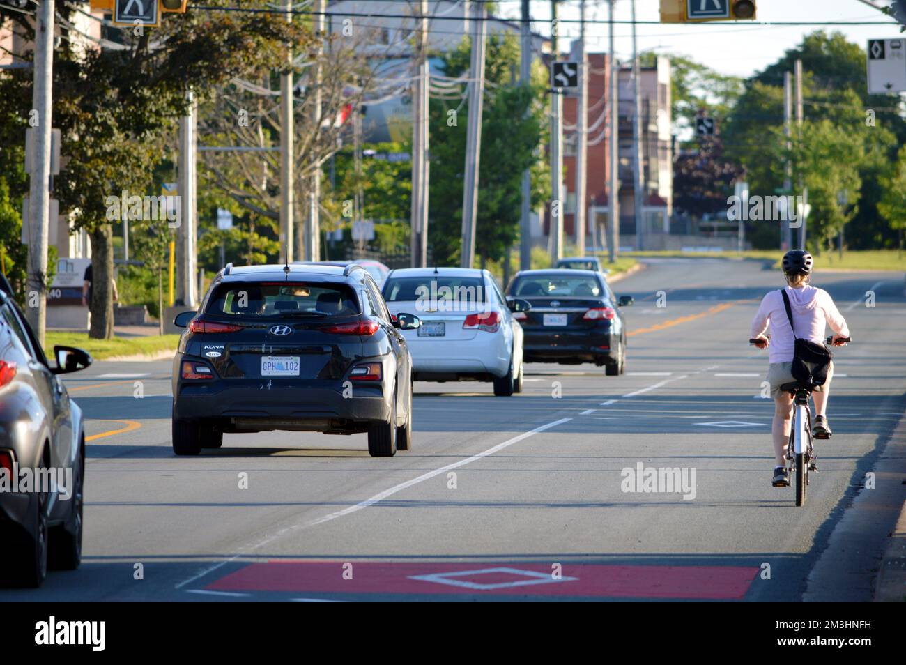 A cyclist on Young Street in Halifax, Nova Scotia, Canada Stock Photo