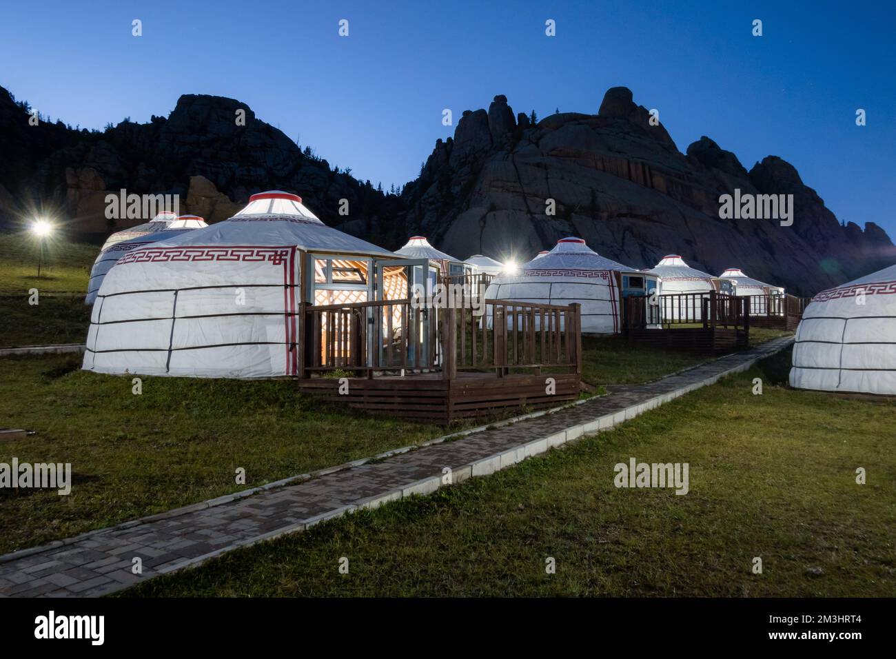 Yurt camp at night, rocky mountains in the background. Ger campsite in ...