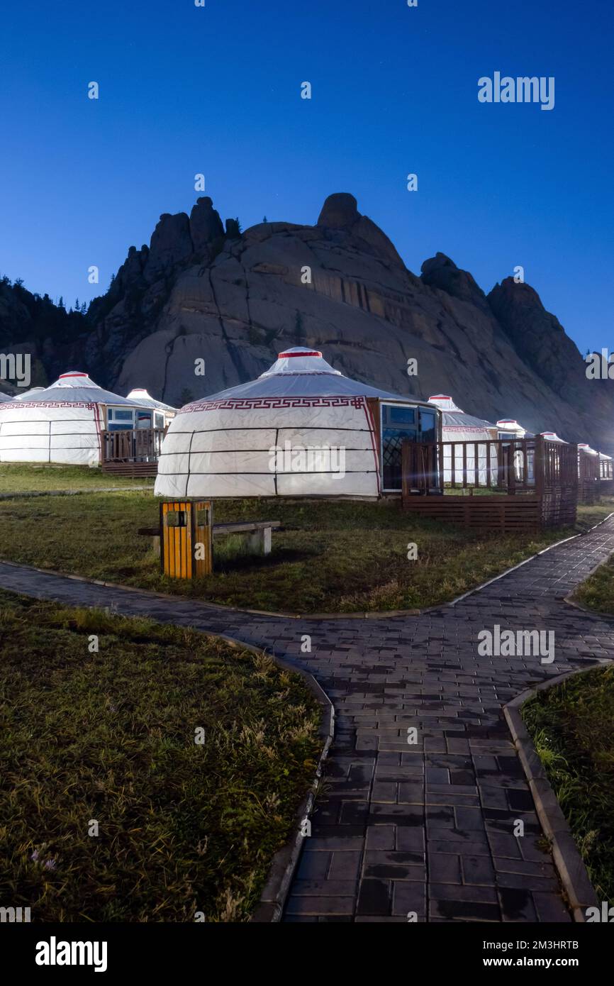 Yurt camp at night, rocky mountains in the background. Ger campsite in ...