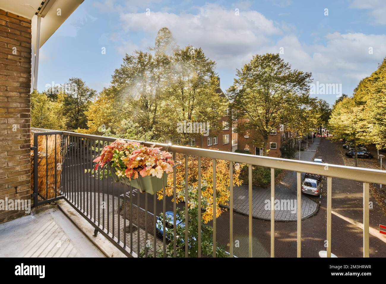 a balcony with flowers on the railings and trees in the back ground, as ...