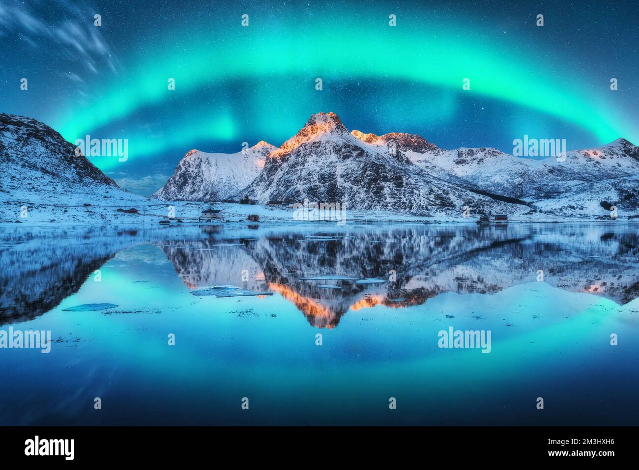 Northern lights over the mountain, sea coast, reflection in water Stock