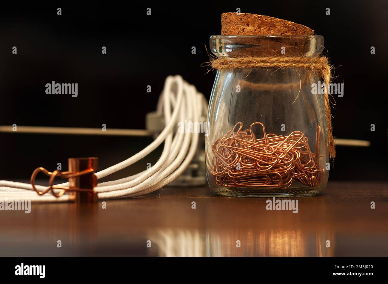 Jar with paper clips on the table Stock Photo