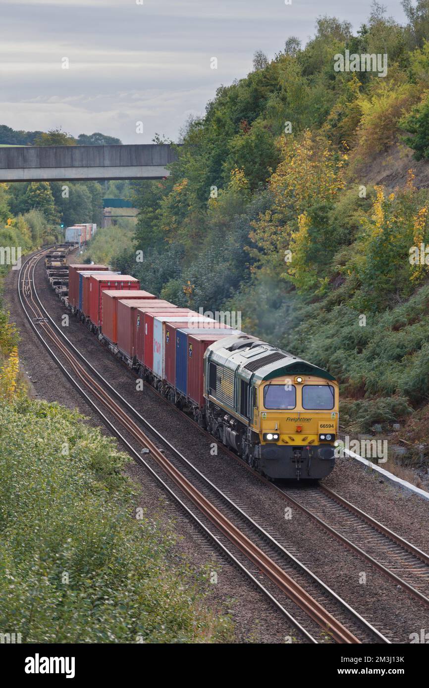 Freightliner class 66 diesel locomotive hauling an intermodal container freight train passing Normanton, Yorkshire, UK Stock Photo