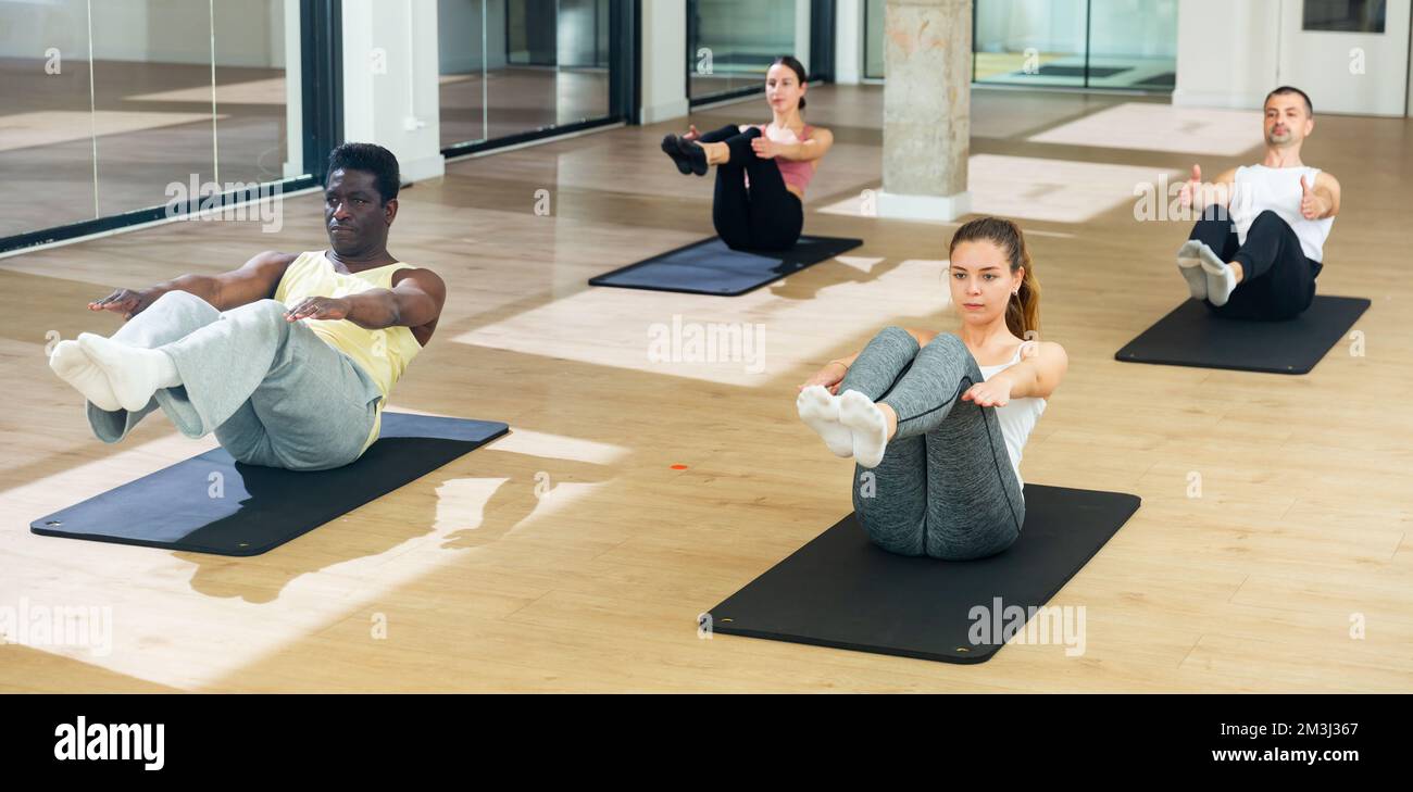 Sporty people practicing pilates at group class Stock Photo - Alamy