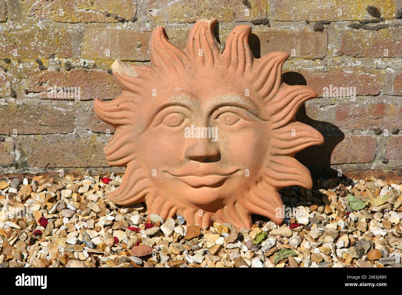 Ornamental terracotta sun face Stock Photo Alamy