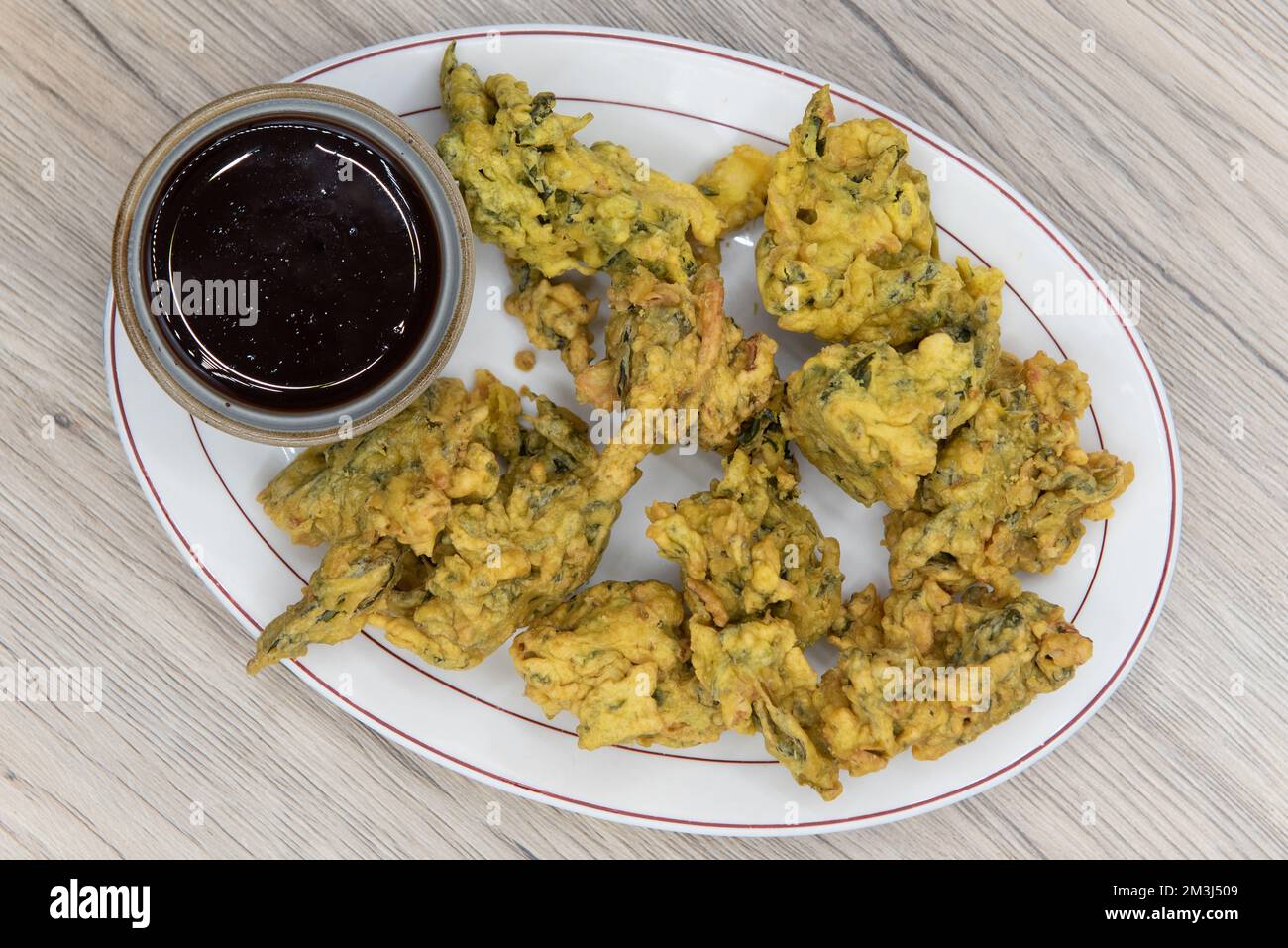 Overhead view of crispy breaded vegetable pakoras served hot on a plate