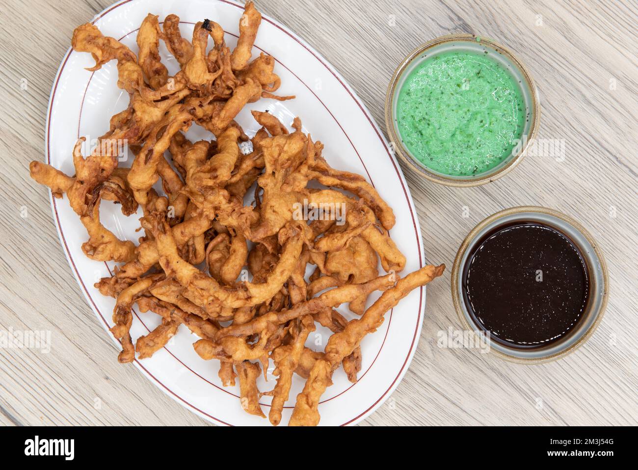 Overhead view of deep fried crispy appetizer of onion bhaji served with