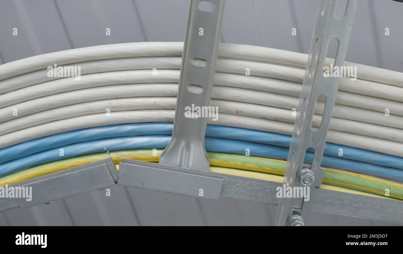 Cables on metal racks. Action. Technical wires lie together. Electrical ...