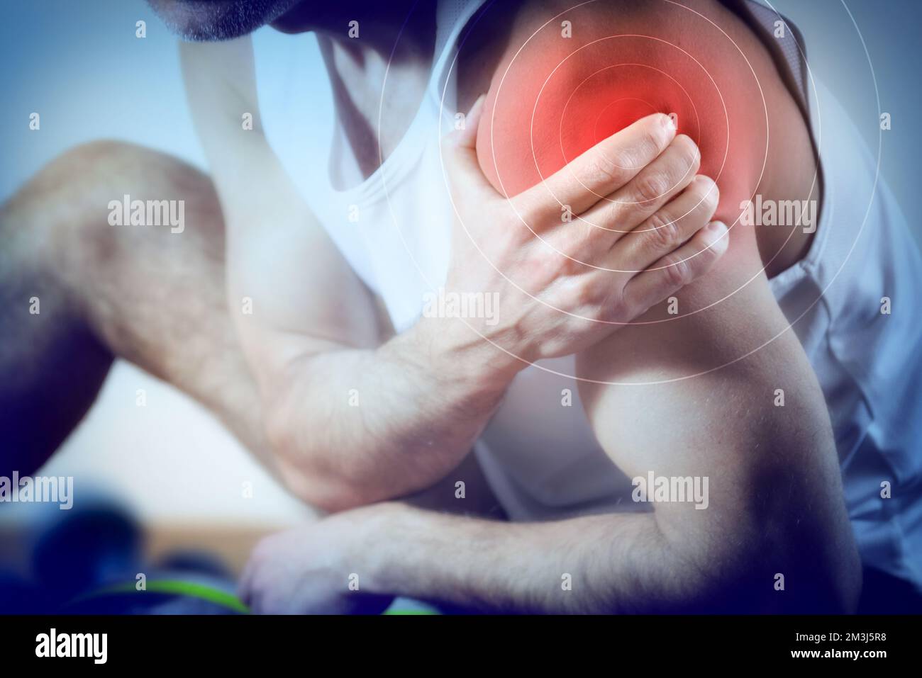 Detail of a representation of pain in the shoulder with red color on a bluish image. Front view. Stock Photo