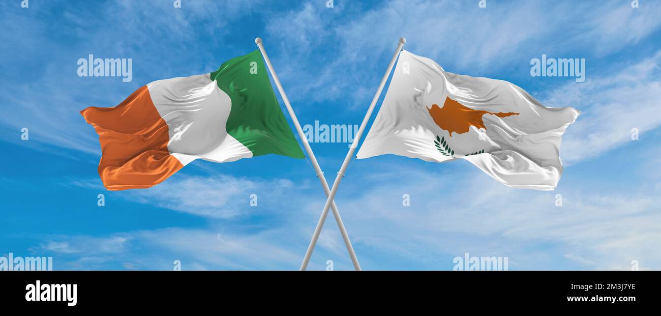 two crossed flags Cyprus and Ireland waving in wind at cloudy sky ...