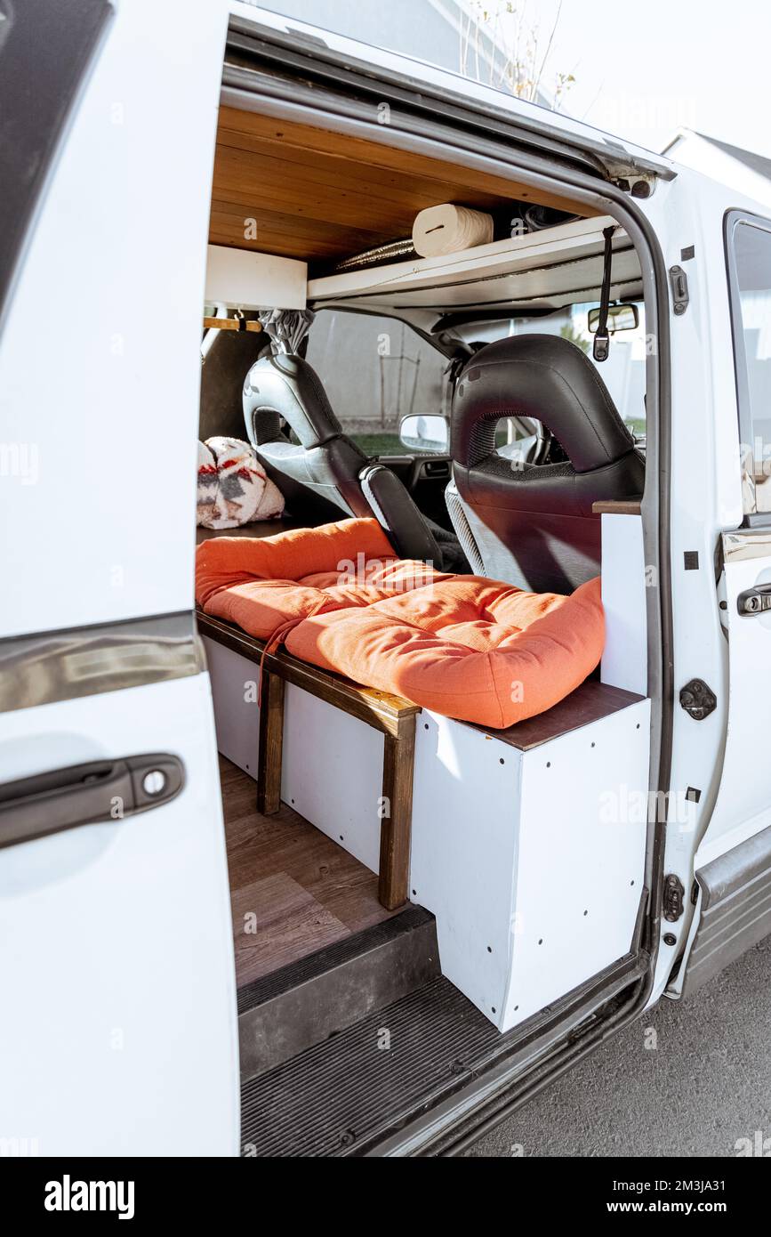 Beautiful bright natural light entering and illuminating an old self converted minivan campervan for van life. The vanlife recreational vehicle has or Stock Photo