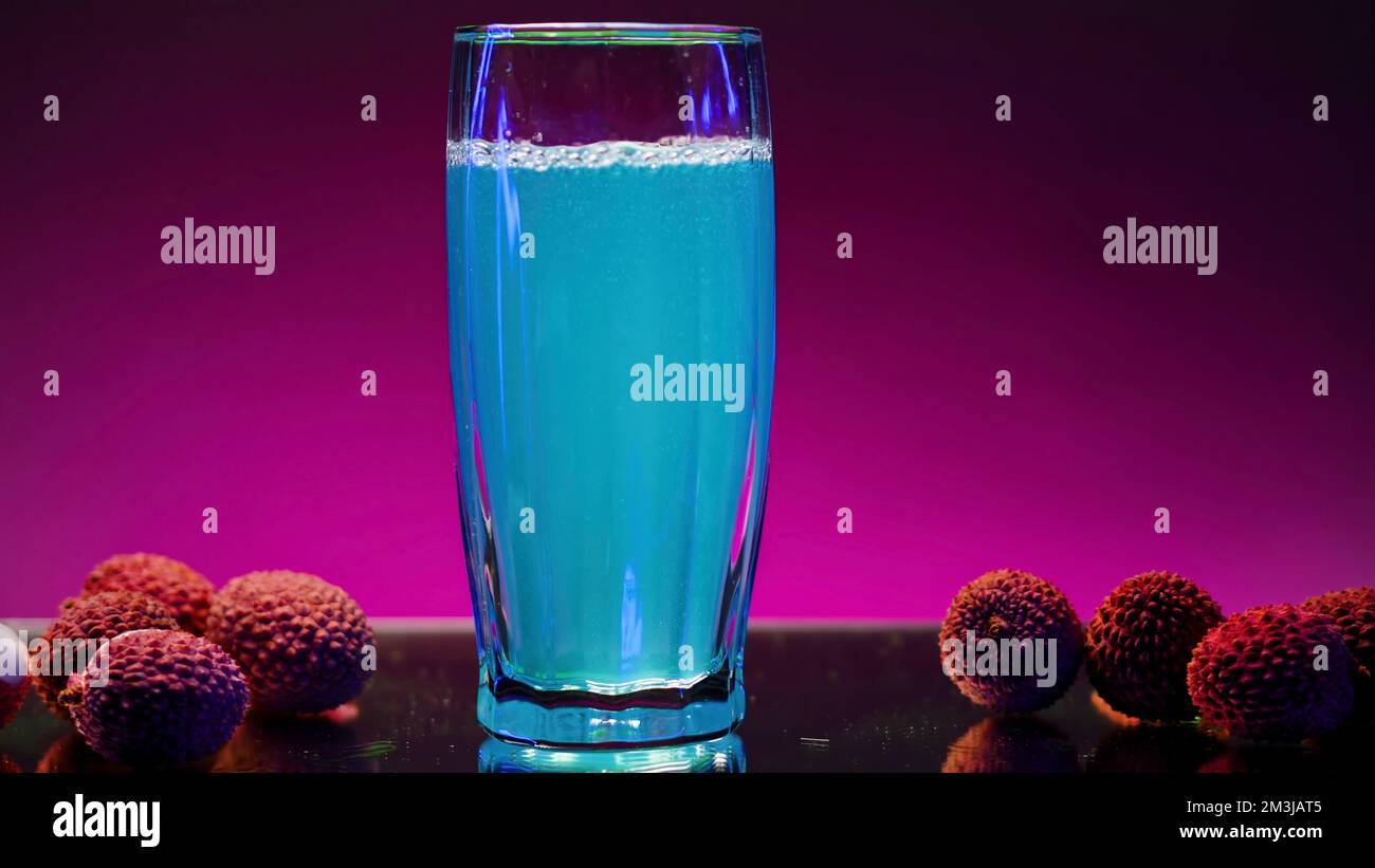 Refreshing non alcoholic beverage of blue color isolated on pink