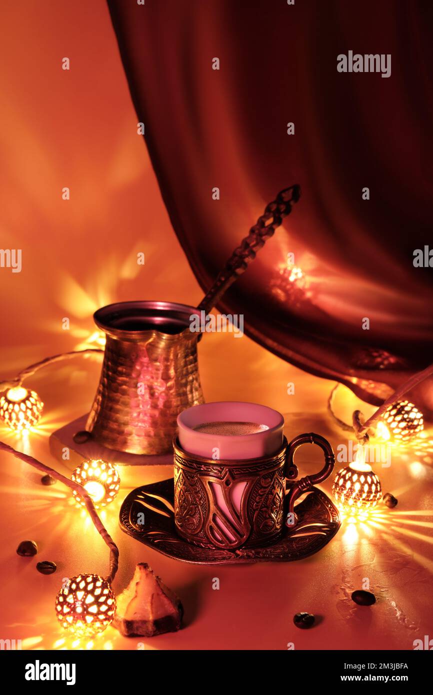 Turkish coffee pot and traditional cup with oriental sweets. Ornate