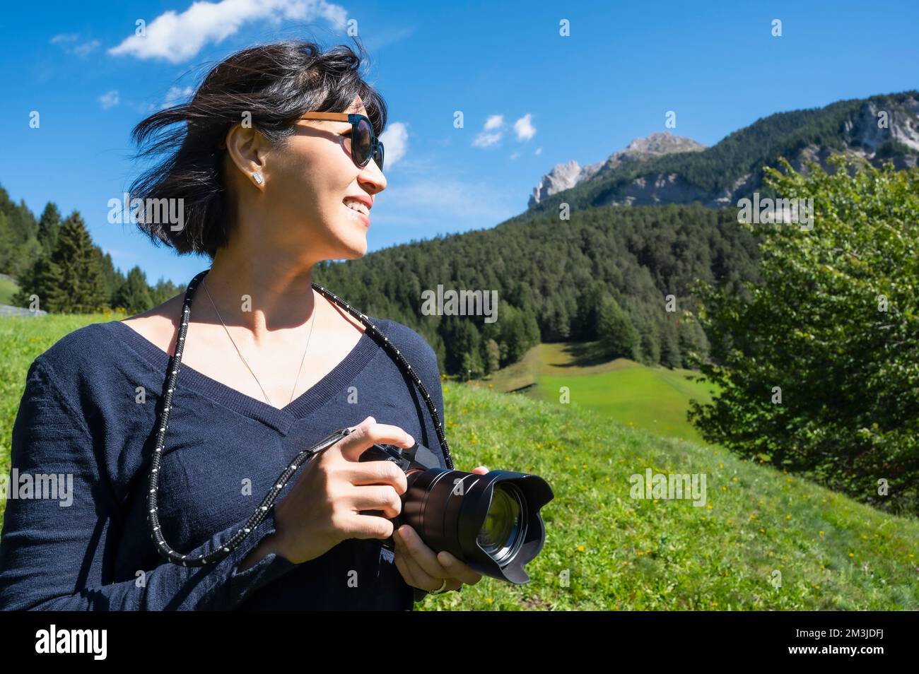 woman taking pictures with digital camera in the Dolomites Stock Photo