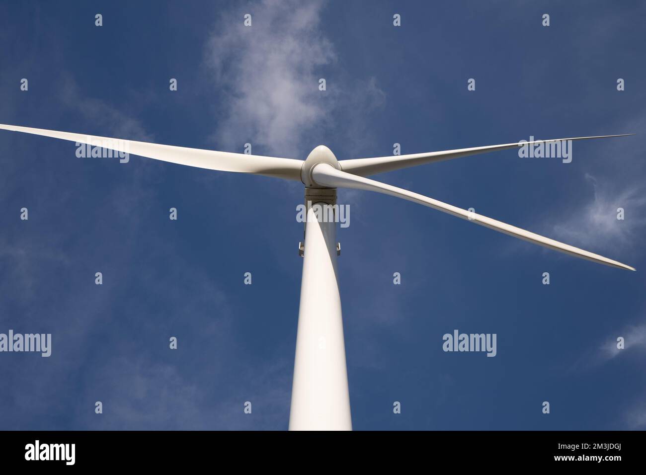 Huge Wind Turbine Tower Generating Electricity -  bottom view Stock Photo