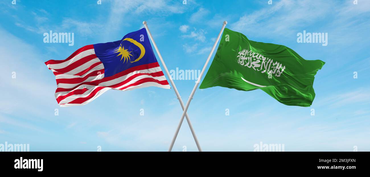 two crossed flags Saudi Arabia and Malaysia waving in wind at cloudy sky. Concept of relationship, dialog, travelling between two countries. 3d illust Stock Photo