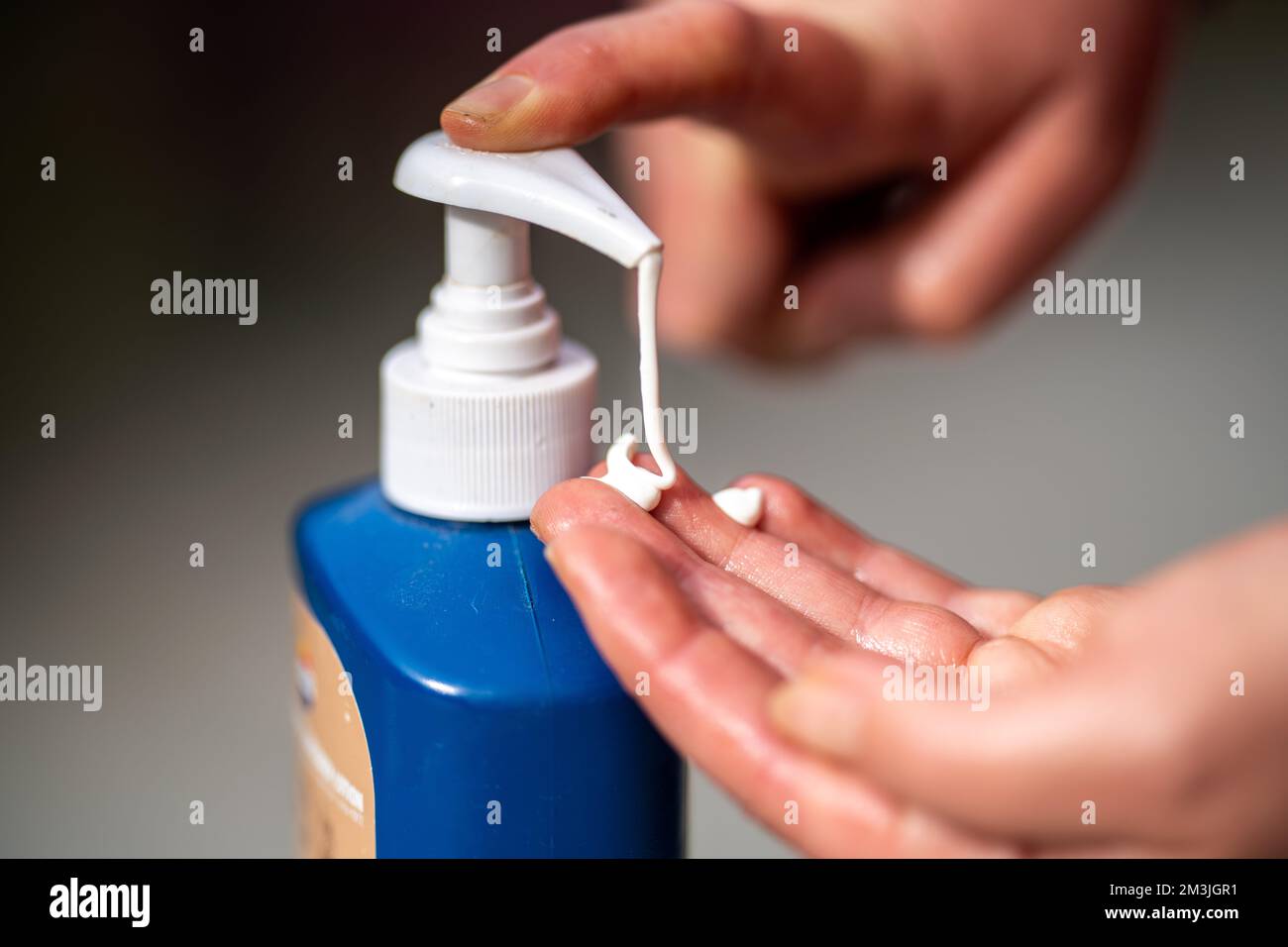 girl applying sunscreen in australia in summer on a deck Stock Photo