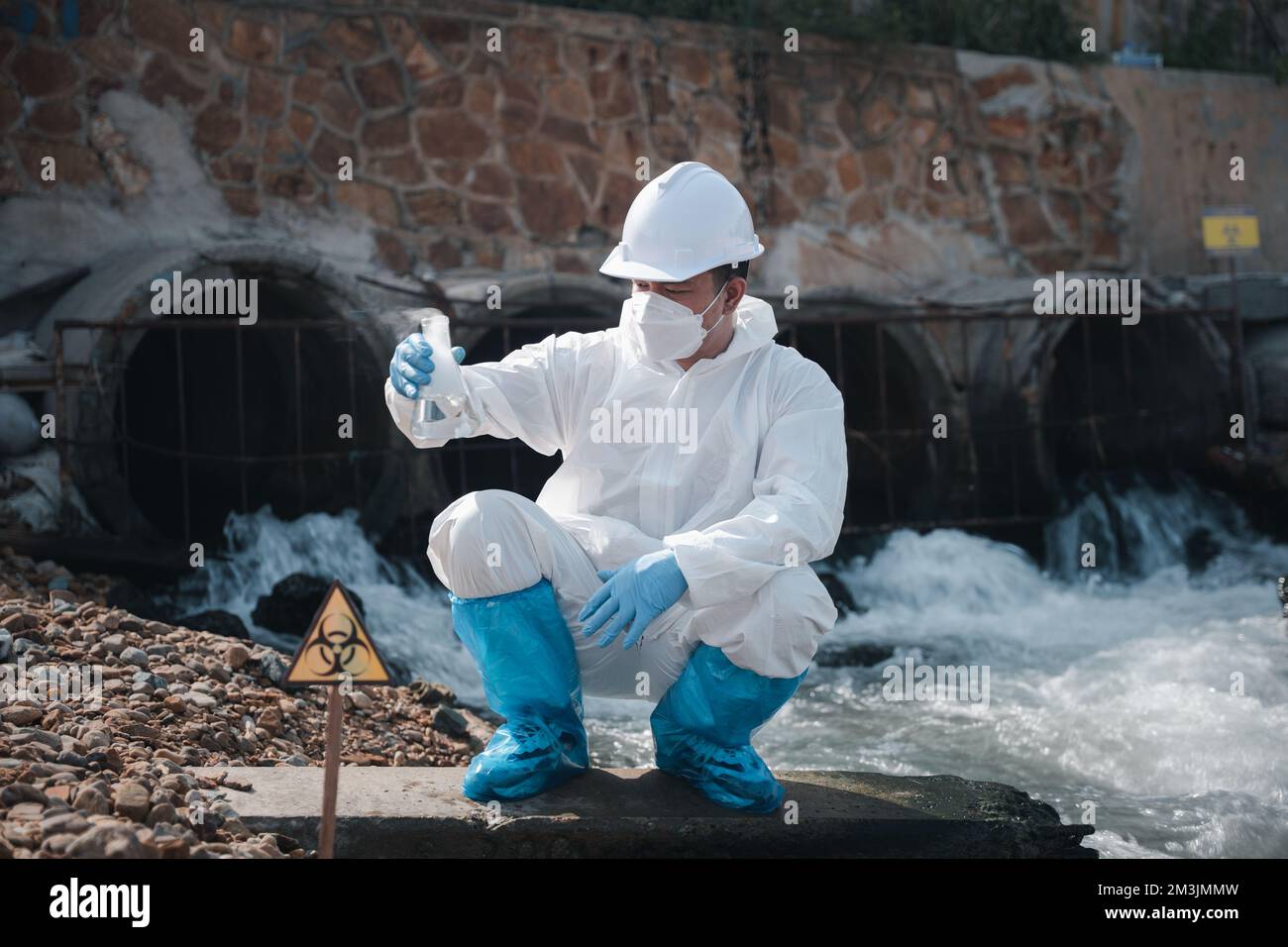 Ecologist sampling water toxic chemicals from river with test tube ...