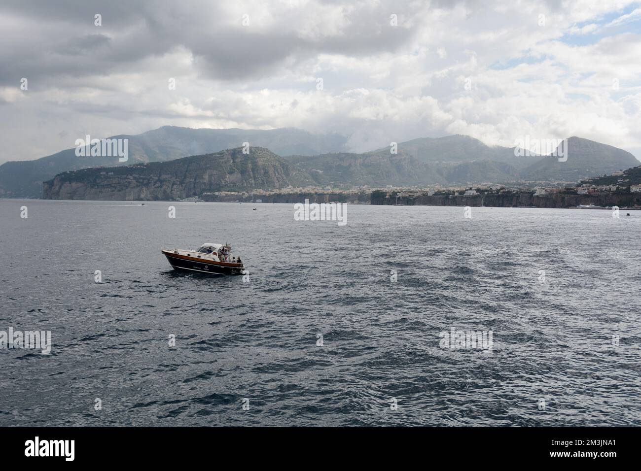 A motorboat in the Bay of Naples and the Italian city of Sorrento in the background, near the Amalfi Coast, in Campania, southern Italy. Stock Photo