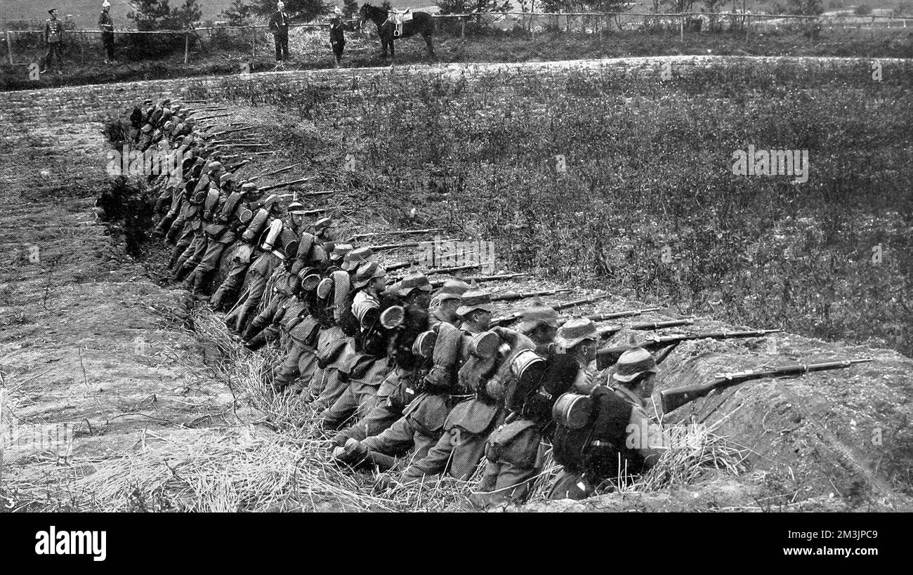 German infantry firing from a trench during training exercises. The