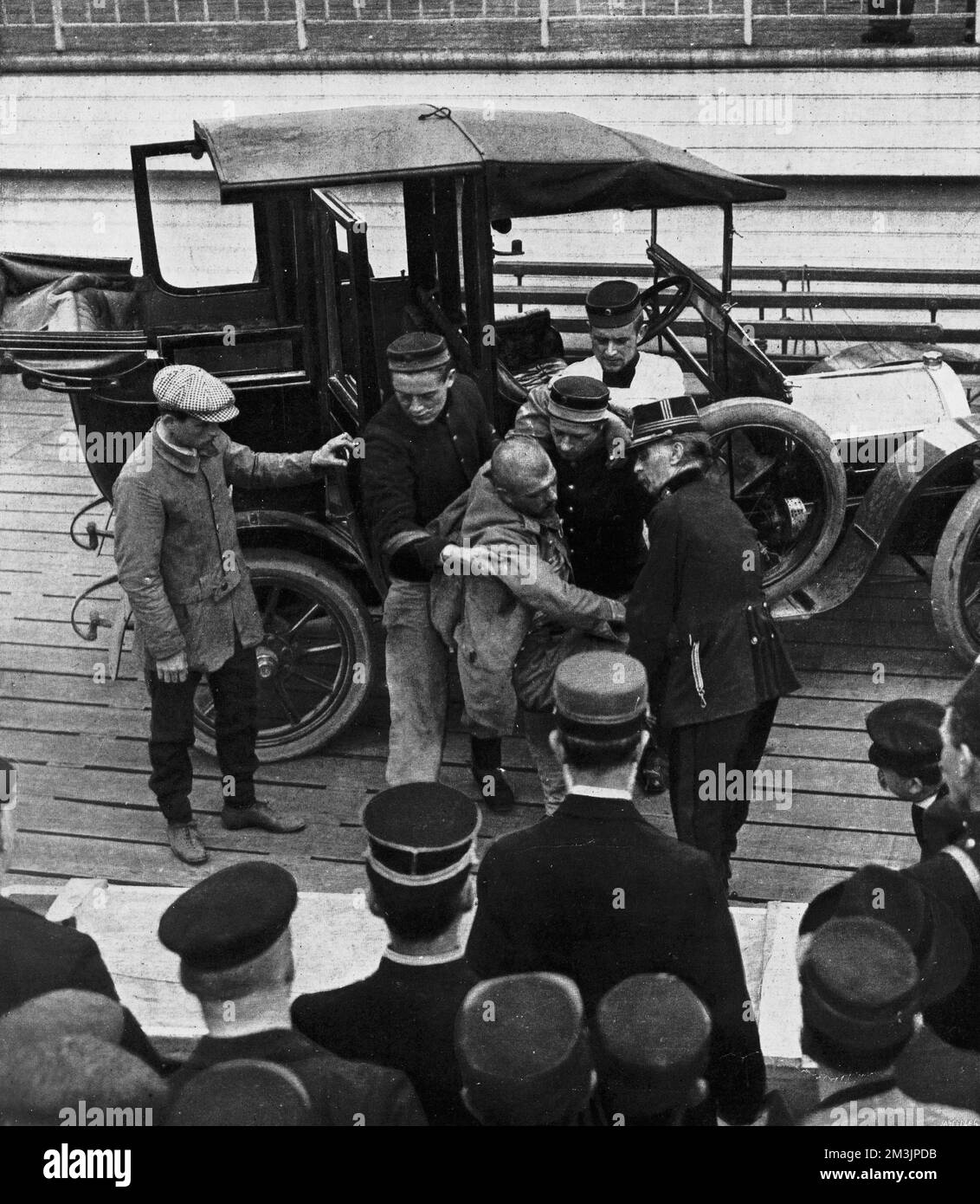 Wounded German cavalry officer being helped out of a motor-car by
