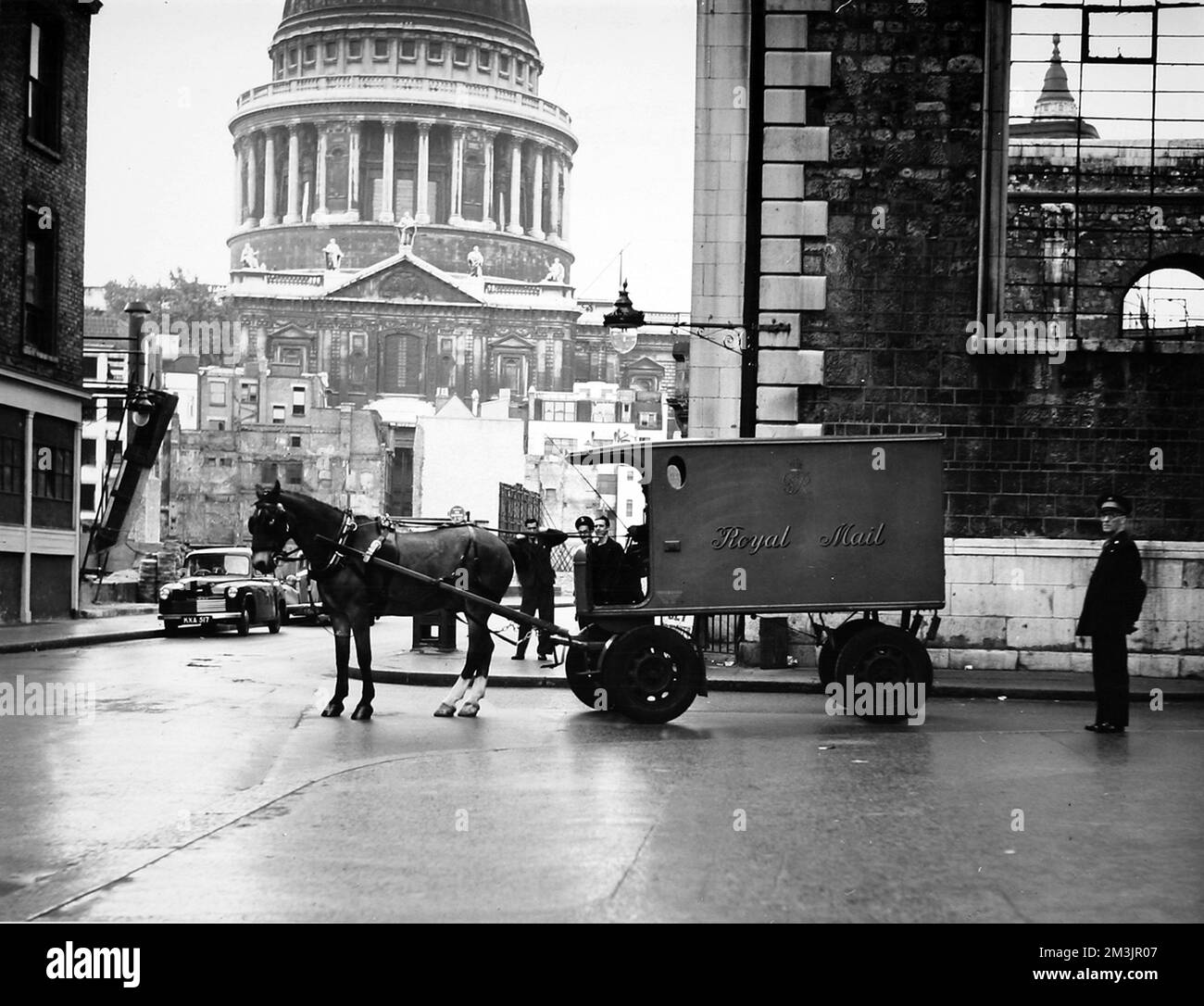 The last horse drawn mail van, 'Peter', leaving K.E.B on Saturday 24th September 1949.  In the background are the still bomb-damaged streets of the St. Pauls area of London.     Date: 24th September 1949 Stock Photo