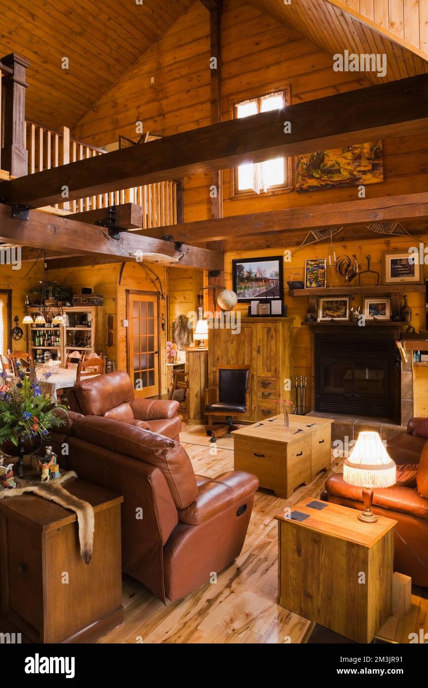 Dark tan leather sofas and pine wood coffee table in living room inside