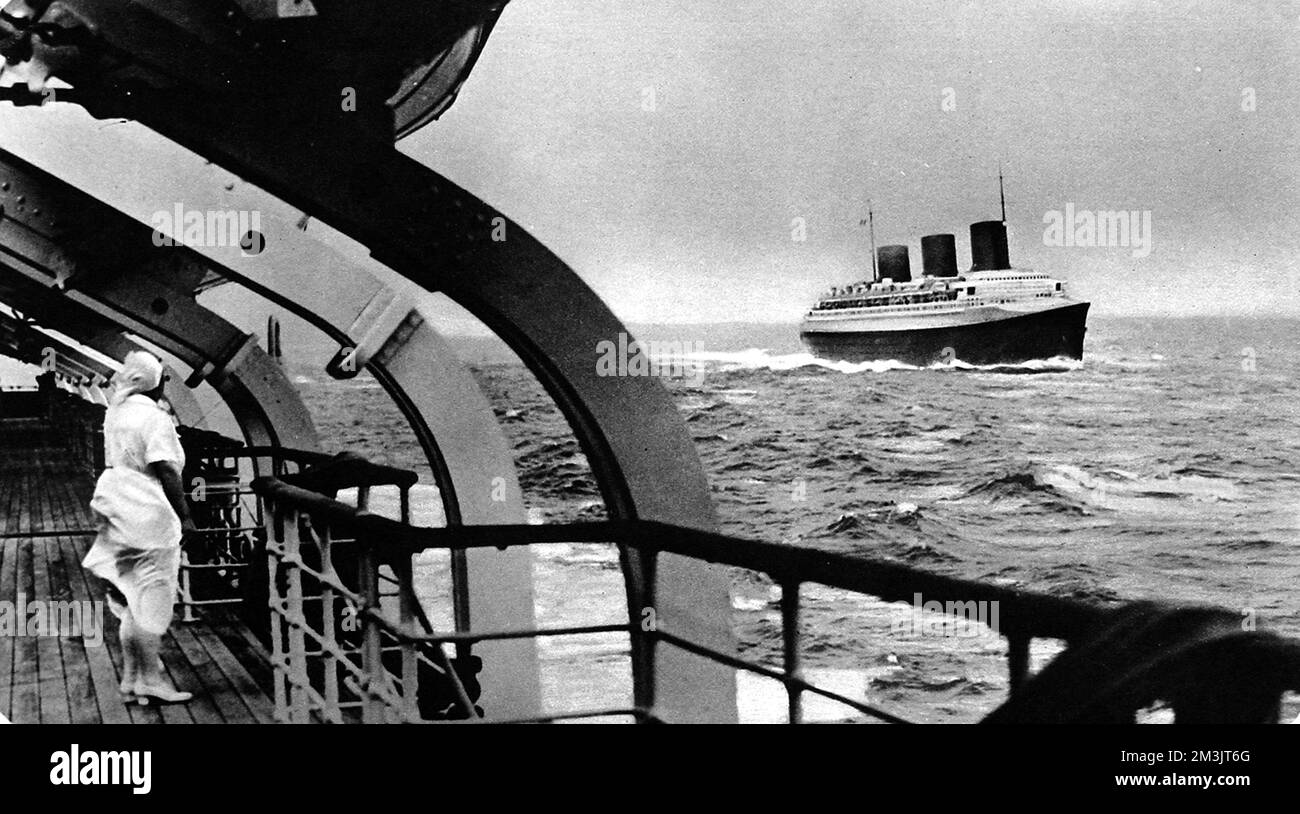 Photograph of the French luxury liner, 'Normandie', in the Atlantic on her maiden voyage, seen from the deck of the 'Champlain'. The 'Normandie' won the Blue Riband quite easily on this voyage, with a crossing time of 4 days and three hours.  1935 Stock Photo