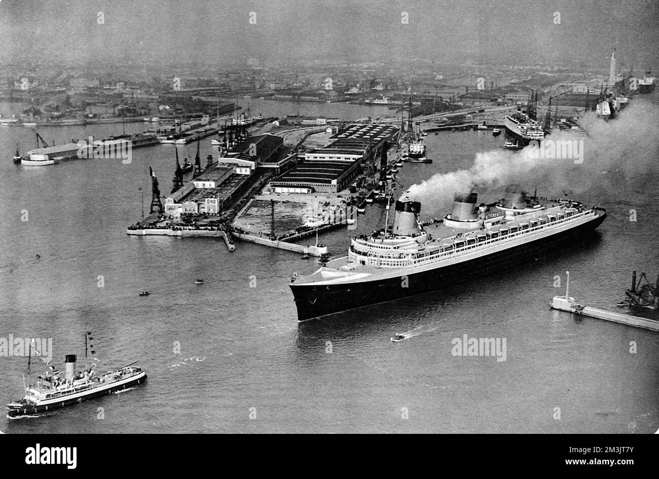 Photograph of the French luxury liner, 'Normandie', leaving Le Havre on her maiden voyage. When she arrived in New York, 4 days and three hours later, she had captured the Blue Riband quite easily, breaking all Atlantic records in the process.  1935 Stock Photo