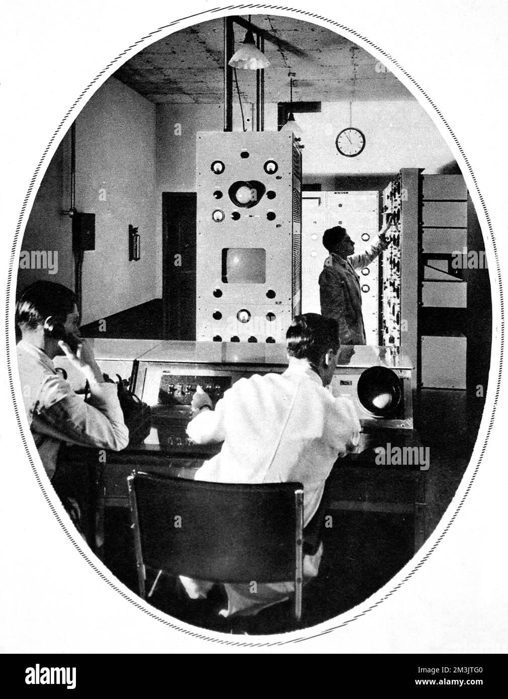 Scene in the heart of the control room of the Baird apparatus. Special tests of reception of the B.B.C from Alexandra Palace of synchronised television and speech were held at Olympia by a committe of the Radio Manufacturers' Association. On alternate days transmissions from Alexandra Palace were given by Baird and Marconi E.M.I systems. In 1935 the B.B.C experimented with John Logie Baird's television system and Marconi's E.M.I system. The E.M.I succeeded Baird's in 1937.  1936 Stock Photo