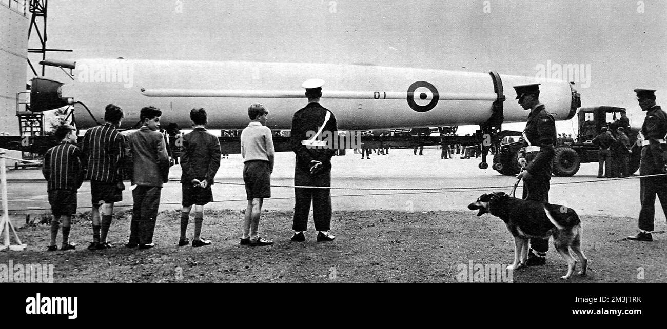 Photograph of the delivery of first 'Thor' Ballistic Missile to an RAF Base in Norfolk, 19th September 1958. Sixty-five feet long, it was carried to the site from a nearby American base on a 90 foot long transporter. The 'Thor's' nuclear war-head was retained by the Americans and any British decision to launch this missile would have been subject to American approval.  RAF Regiment guards can be seen in the foreground, ready to deter any naughty ideas.     Date: 1958 Stock Photo