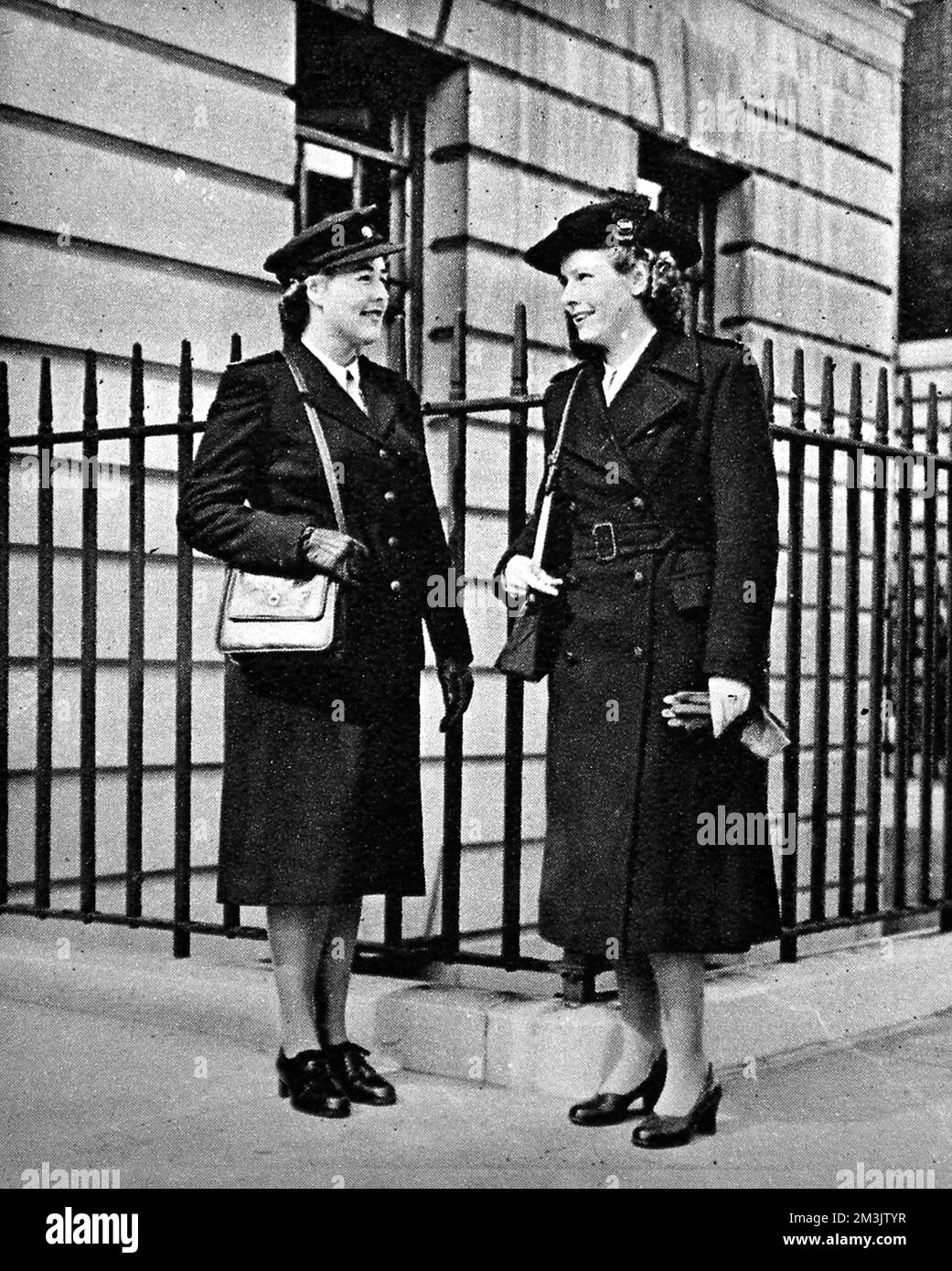 Woman on the left, a single-breasted dark green serge suit, on the right a dark green overcoat. Uniforms designed for state enrolled assistant nurses.  1948 Stock Photo
