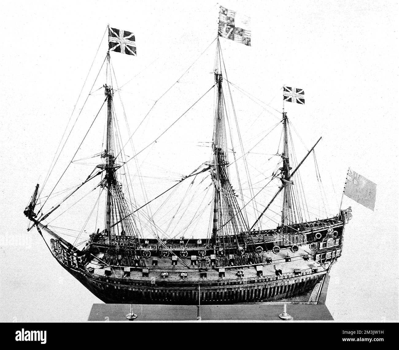 Photograph of a model of an 80-gun ship of Charles the Second's Navy, of about 1680. The model, made of boxwood and walnut, was 53 inches long and was being offered for sale in 1929 by J.M. Botibol of Hanway Street. The flags on the mast-heads and stern were contemporary to 1929, rather than 1680.  1929 Stock Photo