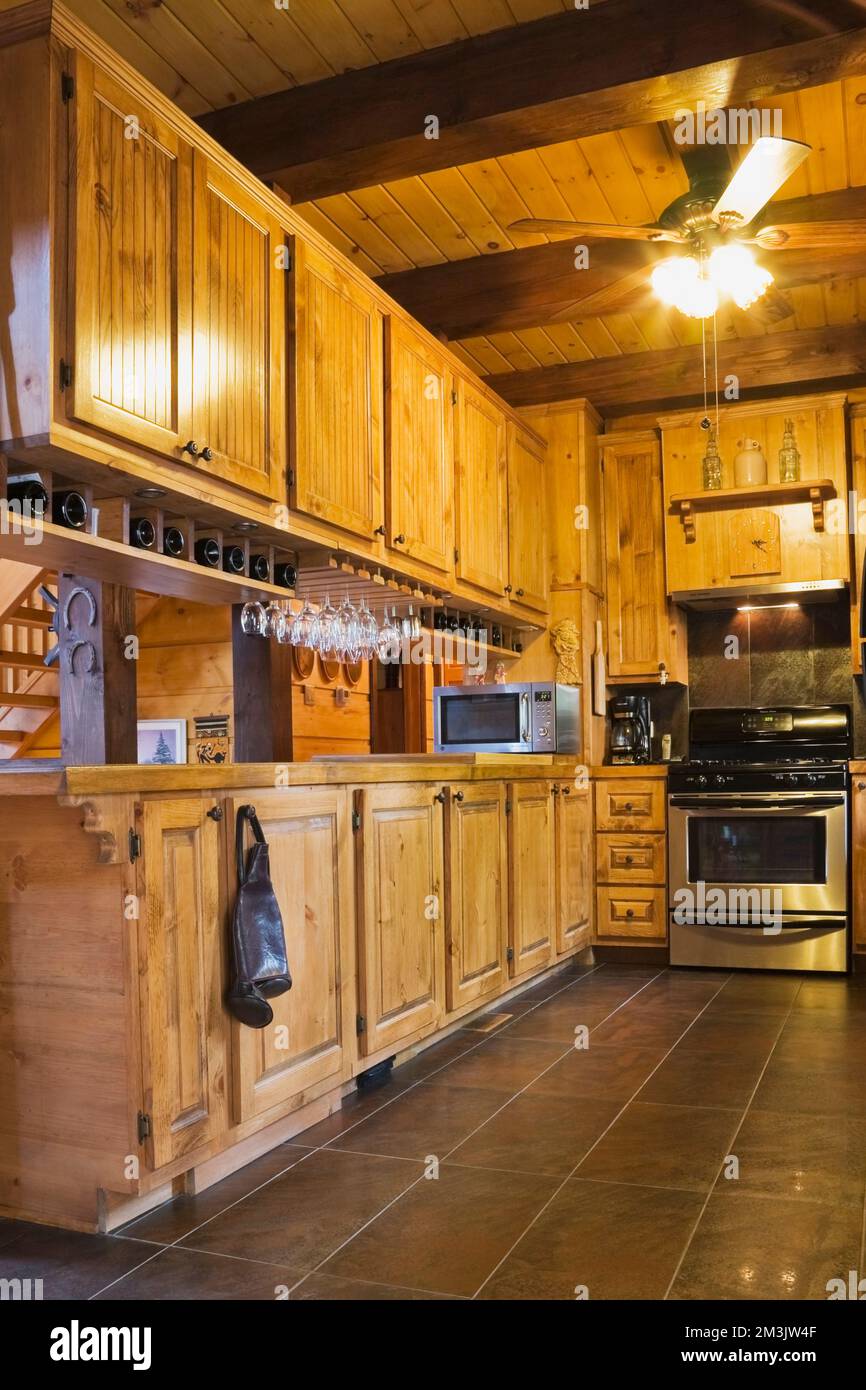Wooden cabinets in kitchen with stainless steel appliances inside piece ...