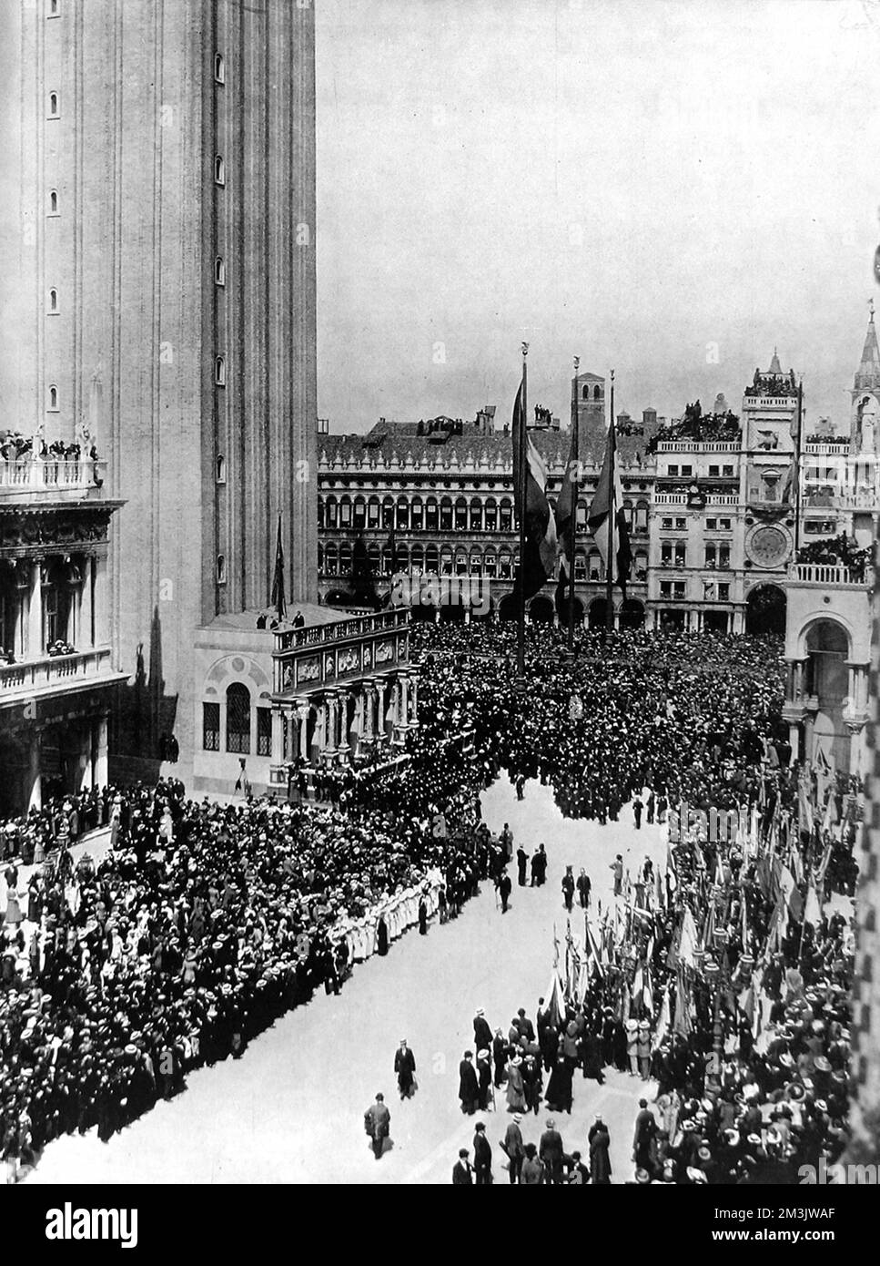 The inauguration of the new Campanile in the Piazza San Marco on St. Mark's Day, 1912. The old Campanile had stood on this site from the sixteenth-century until 14th July 1902, when it collapsed. The new Campanile is an exact replica of the collapsed version, with five bells to mark the hours of the day, the holding of the Grand Council and any executions. Stock Photo