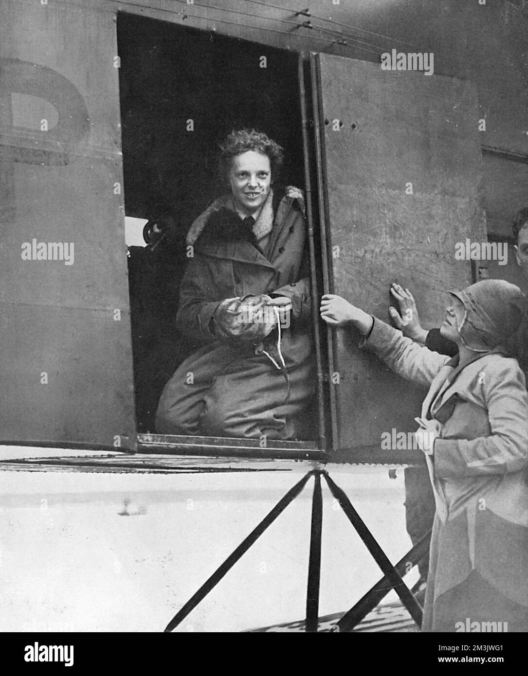 Amelia Earhart (1897 - 1937) moments after she had completed her trans-Atlantic flight in 1928. Although only a passenger, Earhart was the first woman to fly the Atlantic. Bothered by the fact that her pilots on this historic journey had been given no credit, she resolved to fly solo, finally achieving her goal in May 1932 when she flew from Newfoundland to Northern Ireland. Earhart's plane went missing during a round-the-world flight with her navigator, Frederick Noonan in 1937.  1928 Stock Photo