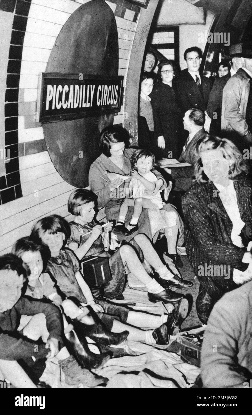 Londoners using an underground station as bomb shelter during an air raid.  1940 Stock Photo