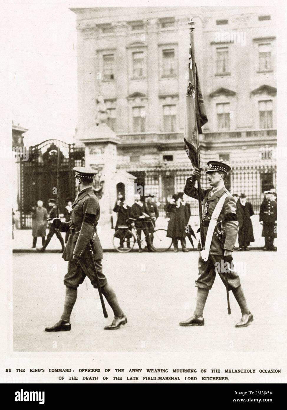 Two British officers of the Scots Guards bearing the Colour at the changing of the guard at Buckingham palace. The two soldiers are seen in black crepe armbands, as ordered by the King, following the death of Lord Kitchener (1850-1916). Kitchener died on the 5th June 1916 when the ship he was aboad, the HMS Hampshire, struck a mine and sank off Orkney. Stock Photo