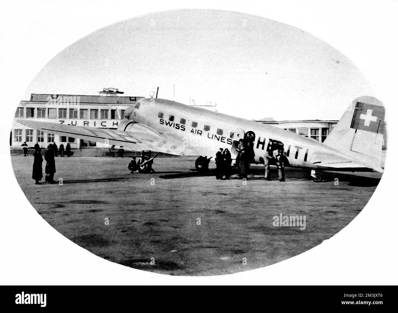 Photograph of a Swissair aeroplane, of a type used between London and Zurich in 1936, seen at Zurich Airport.      Winter flights between Croydon Airport and Zurich had just been introduced by Swissair and Imperial Airways, to provide a service for the growing numbers of holiday-makers going ski-ing.     Date: 1936 Stock Photo