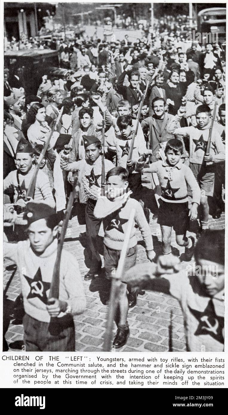 Children, dressed in Communist jumpers and with toy rifles, marching through the streets of Madrid during the Spanish Civil War, 1936. The children are shown giving the Socialist clenched-fist salute. Stock Photo
