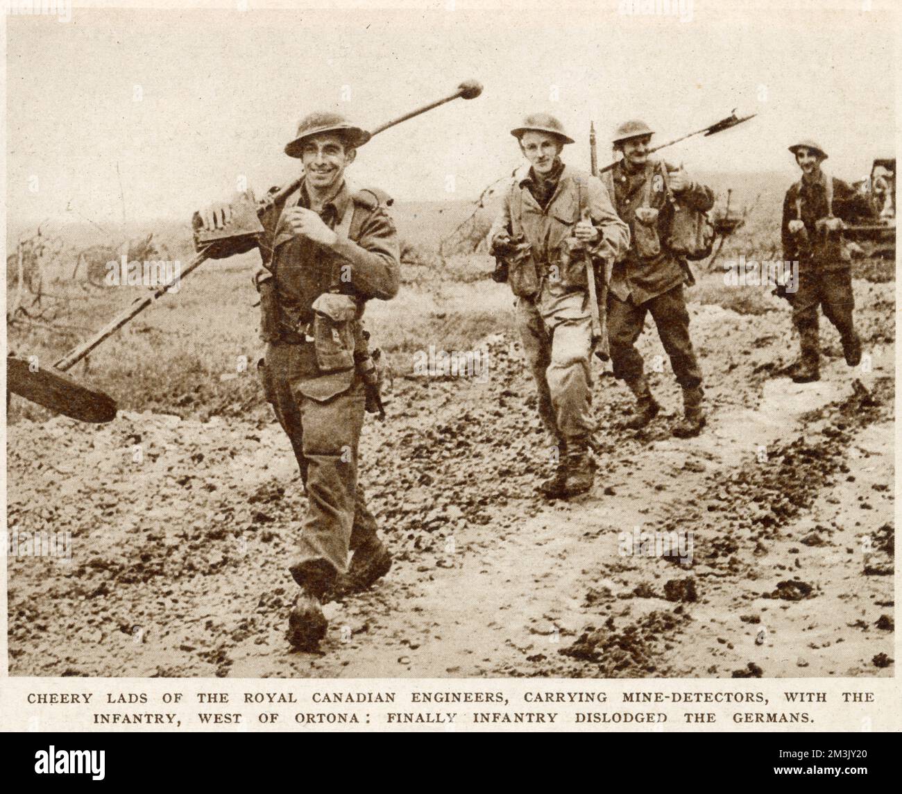 Men of the Royal Canadian Engineers, carrying mine-detectors, moving west of Ortona, Italy, during December 1943.   These men were serving with the Allied army as it pushed northwards through Italy, against Italian and German resistance, in 1943 and 1944. Stock Photo