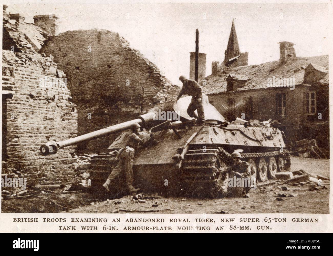 Several British soldiers examining an abandoned German Royal Tiger tank, near Falaise, 1944. This heavy tank was reported to weigh 65 tons, with 6-inch armour plating and an 88-mm gun. Stock Photo