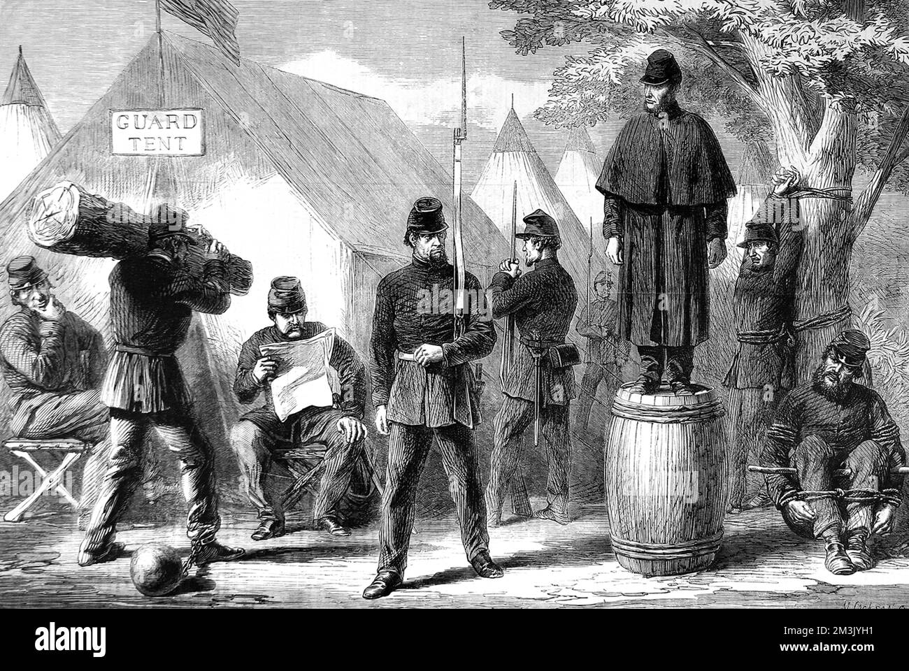 Federal soldiers patrolling and keeping guard over  prisoners. One is tied to a tree while another is seated on the ground tied to a post.     Date: 1861 Stock Photo