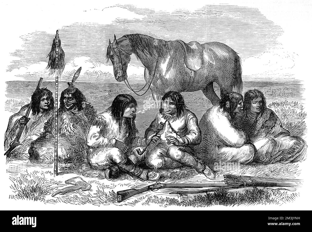 A group of male Prairie Cree Indians smoking long pipes and talking together. The Cree are wearing fringed buckskin and feathers in their hair, with rifles and a hatchet in the foreground and a horse in the background. Stock Photo