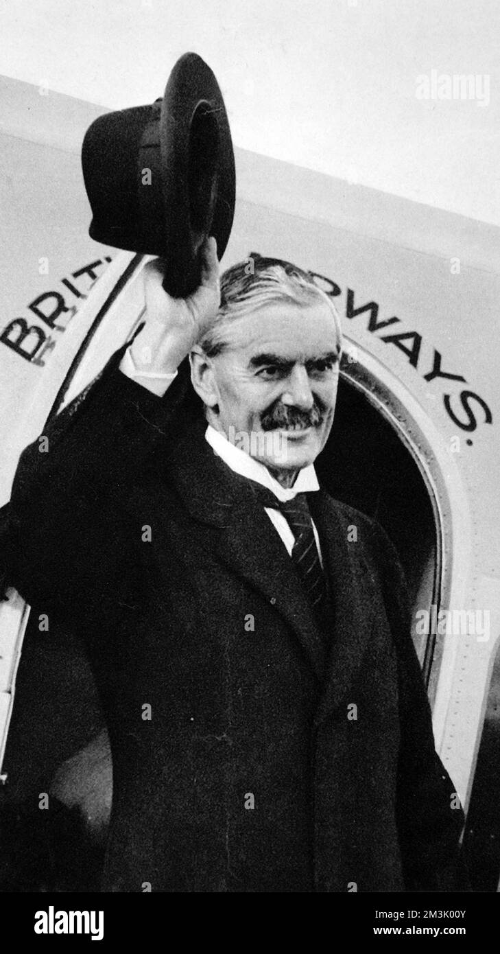 Neville Chamberlain (1869 - 1940), British Prime Minister, waving goodbye as he boards an airplane at Heston, England on his way to Godesberg to meet Adolf Hitler, Germany's Fuhrer, to hold talks regarding the Sudetenland. Chamberlain's policy of 'appeasement' was fiercely opposed by Winston Churchill. Stock Photo