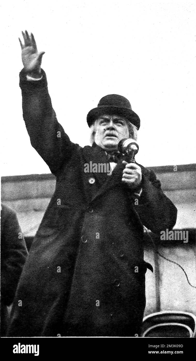 David Lloyd George, 1st Earl Lloyd George of Dwyfor (1863 - 1945), Welsh Liberal statesman, addressing a large crowd at Rochdale during the election campaign of 1923. Forgetting he was using a microphone to address the people of Rochdale (previously represented by Richard Cobden), Lloyd George asked 'aside' to a supporter 'Was Cobden a Lancashire man?'. The microphone picked up the 'aside', causing a great deal of laughter in the crowd.     Date: 1923 Stock Photo