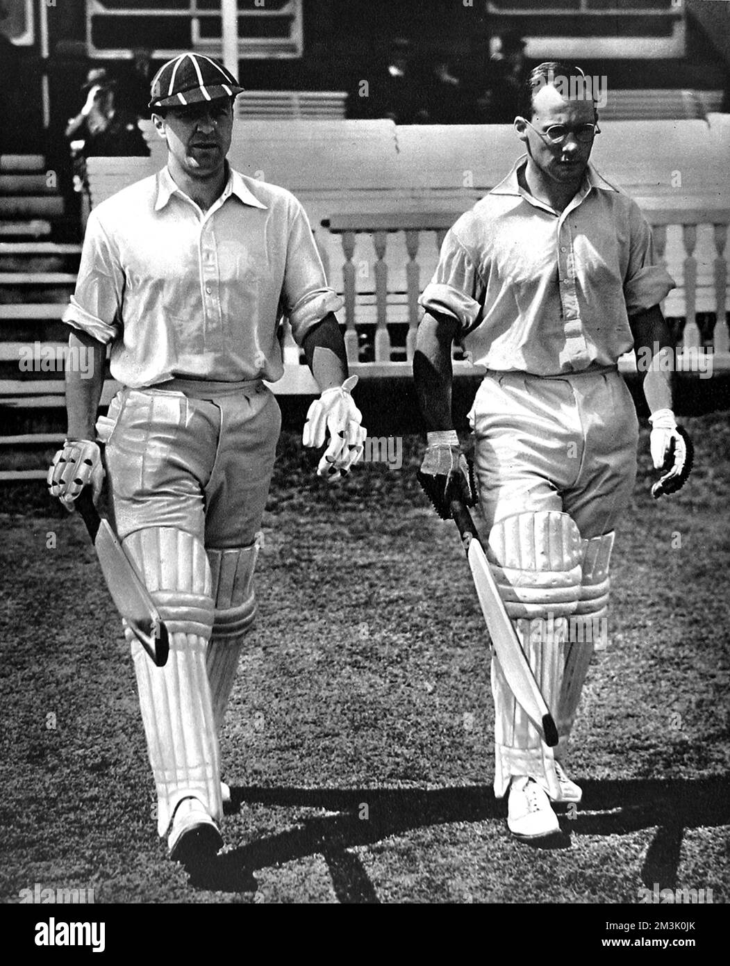 Photograph of B.O. Allen (Captain of Gloucestershire CCC) and P.A. Gibb (Cambridge University and Yorkshire) walking out of the pavilion to open the innings for the 'Gentleman's Team', in the match against the 'Players', held at Lord's Cricket Ground, July 1938.     Date: 1938 Stock Photo