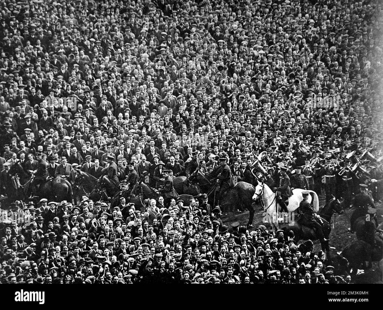 The crowd at Wembley Stadium before the start of the 1923 F.A. Cup Final between Bolton Wanderers and West Ham United. This was the first Cup Final held at the then brand-new Wembley Stadium, which had been built in 300 days at a cost of ??750,000.  Before the match began a crowd of about 100,000 (most without a ticket) stormed through the gates and into the stadium. This meant that there was approximately 200,000 people in a ground designed for 127,000.   The photograph shows the scene as the Band (on right) play the National Anthem and the few mounted policemen attempt to maintain order. Pro Stock Photo