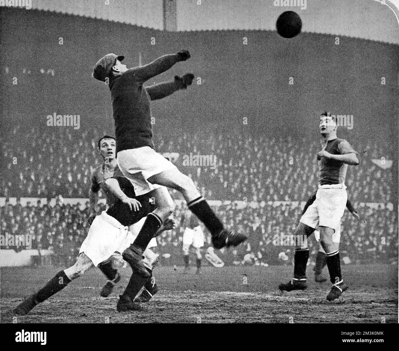 Photograph showing the Mansfield Town goalkeeper jumping highest to 