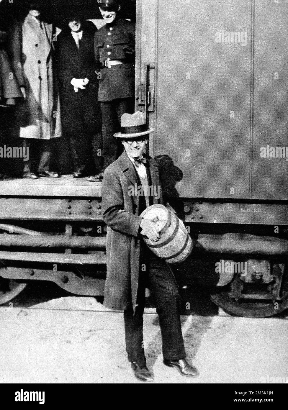 Photograph of man holding keg containing gold worth 1,500,000 francs, as the gold arrives in France.     Date: 1831 Stock Photo